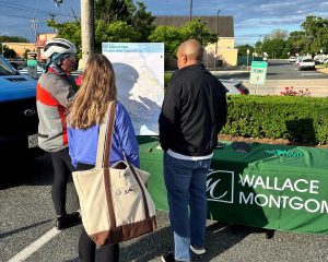 Harford county biking event showing Wallace Montgomery table and biking map with people standing around looking at the map.
