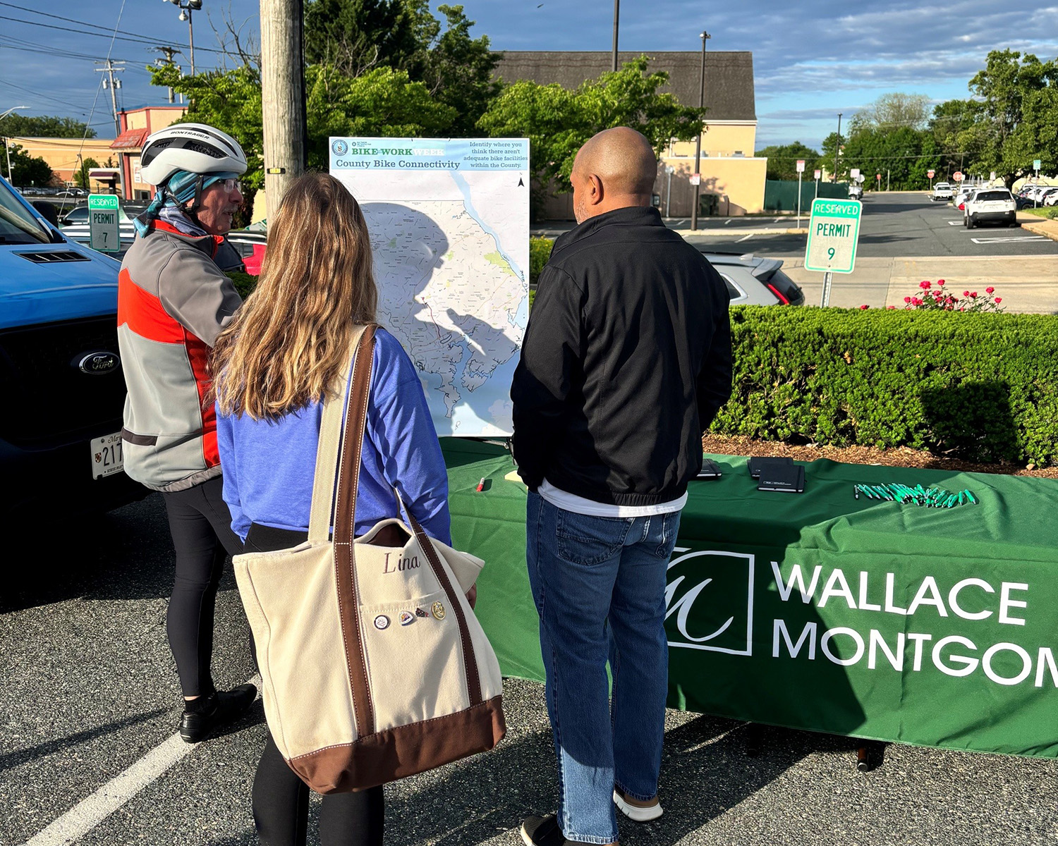 Harford county biking event showing Wallace Montgomery table and biking map with people standing around looking at the map.